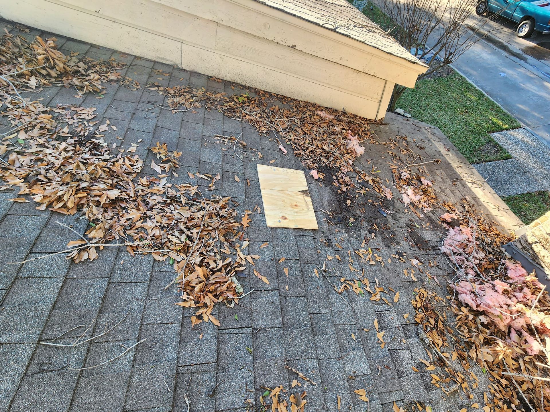 There is a piece of wood on the roof of a house.