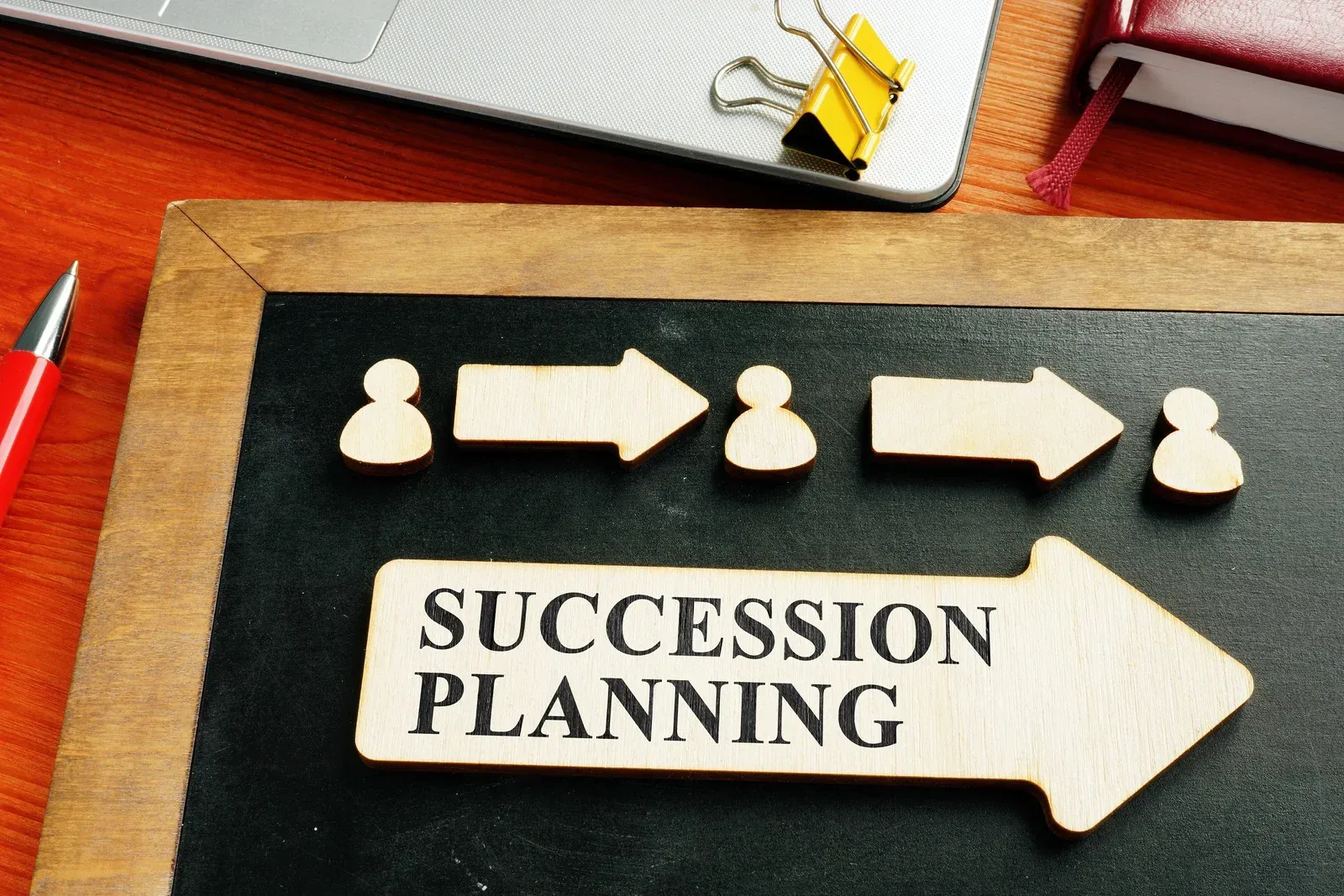 A blackboard with arrows and the words succession planning on it