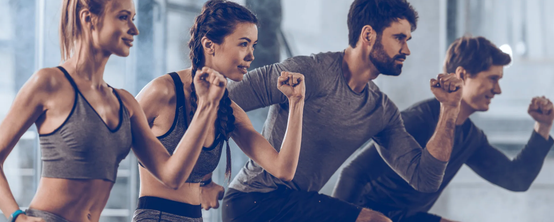 A group of people are standing next to each other in a gym.