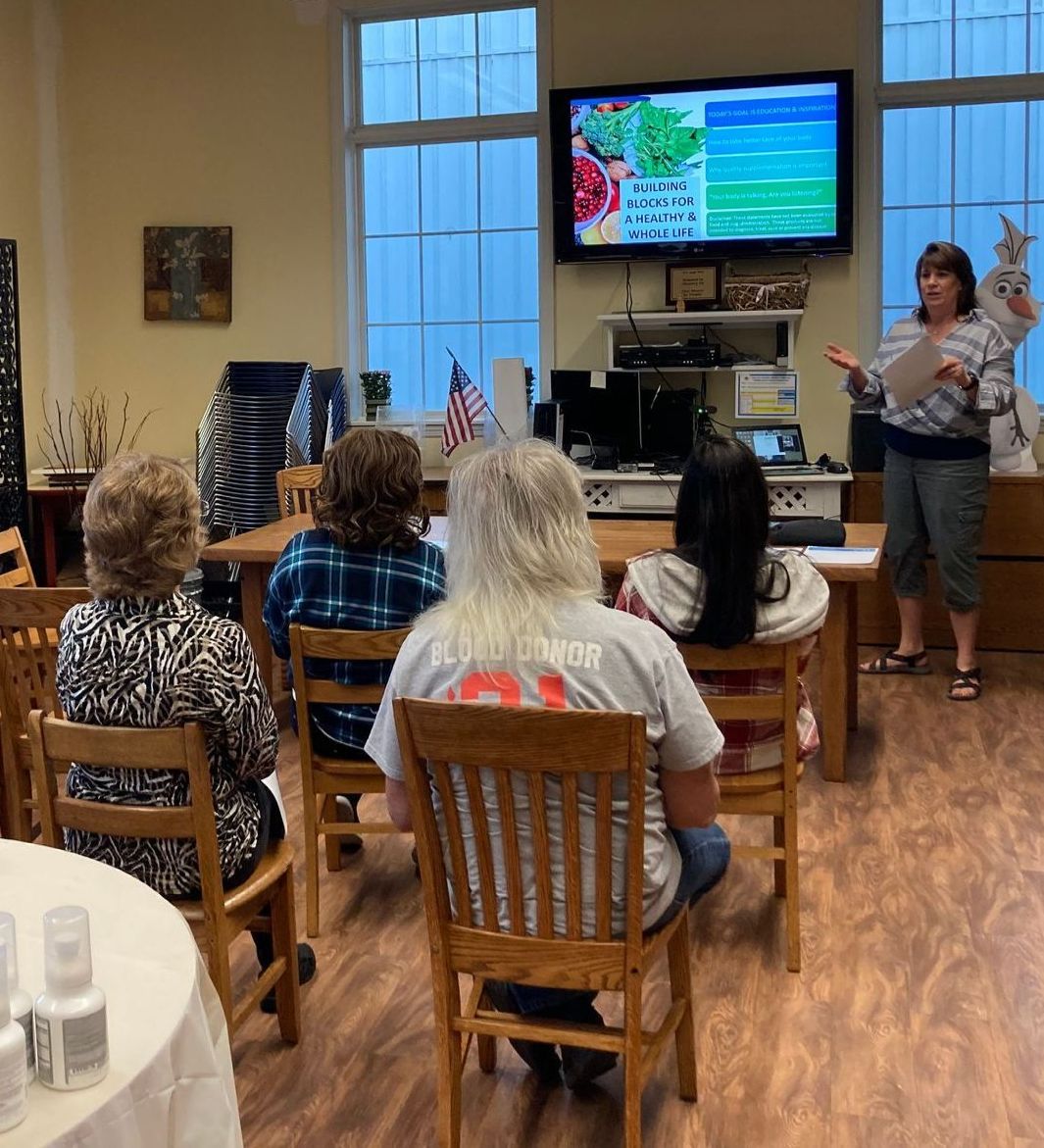 A woman is giving a presentation to a group of people