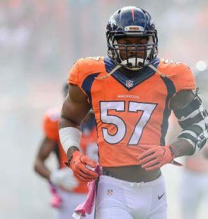 A football player with the number 57 on his jersey is running on the field.