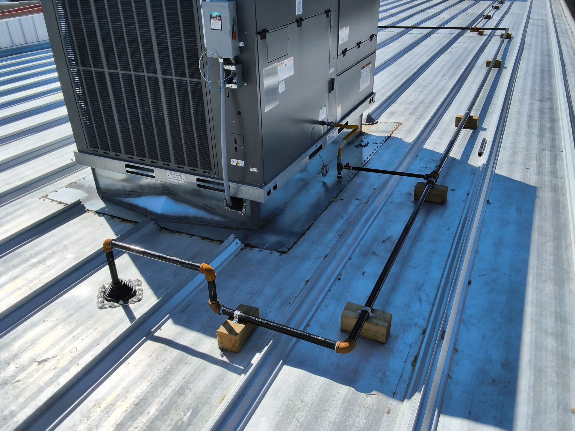 Gas piping installation on a commercial rooftop