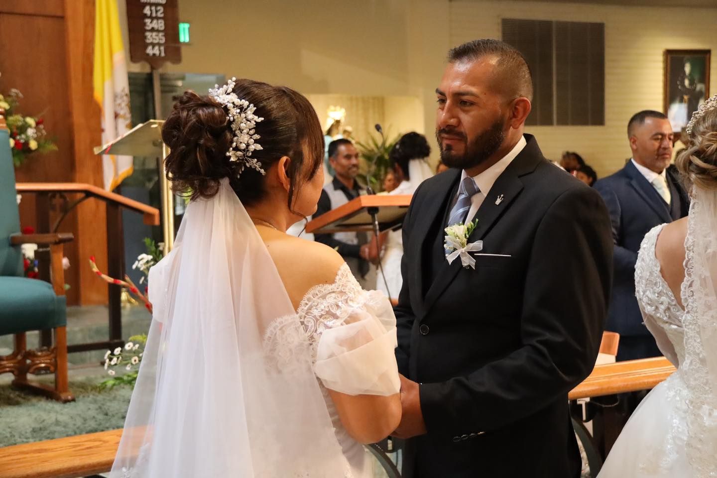 Bride and groom holding hands during a wedding ceremony in a church