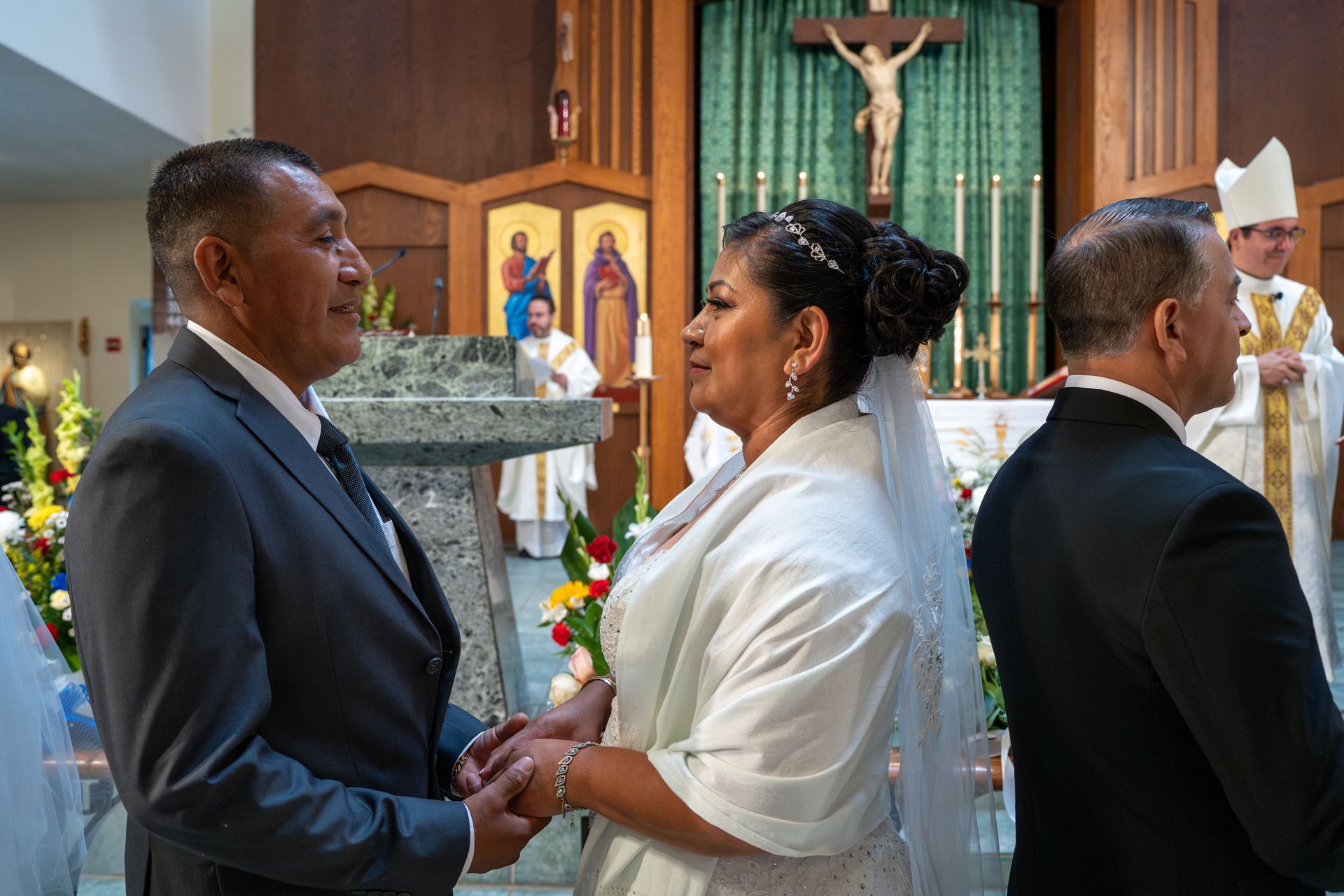 Bride and groom holding hands in a church during a wedding ceremony