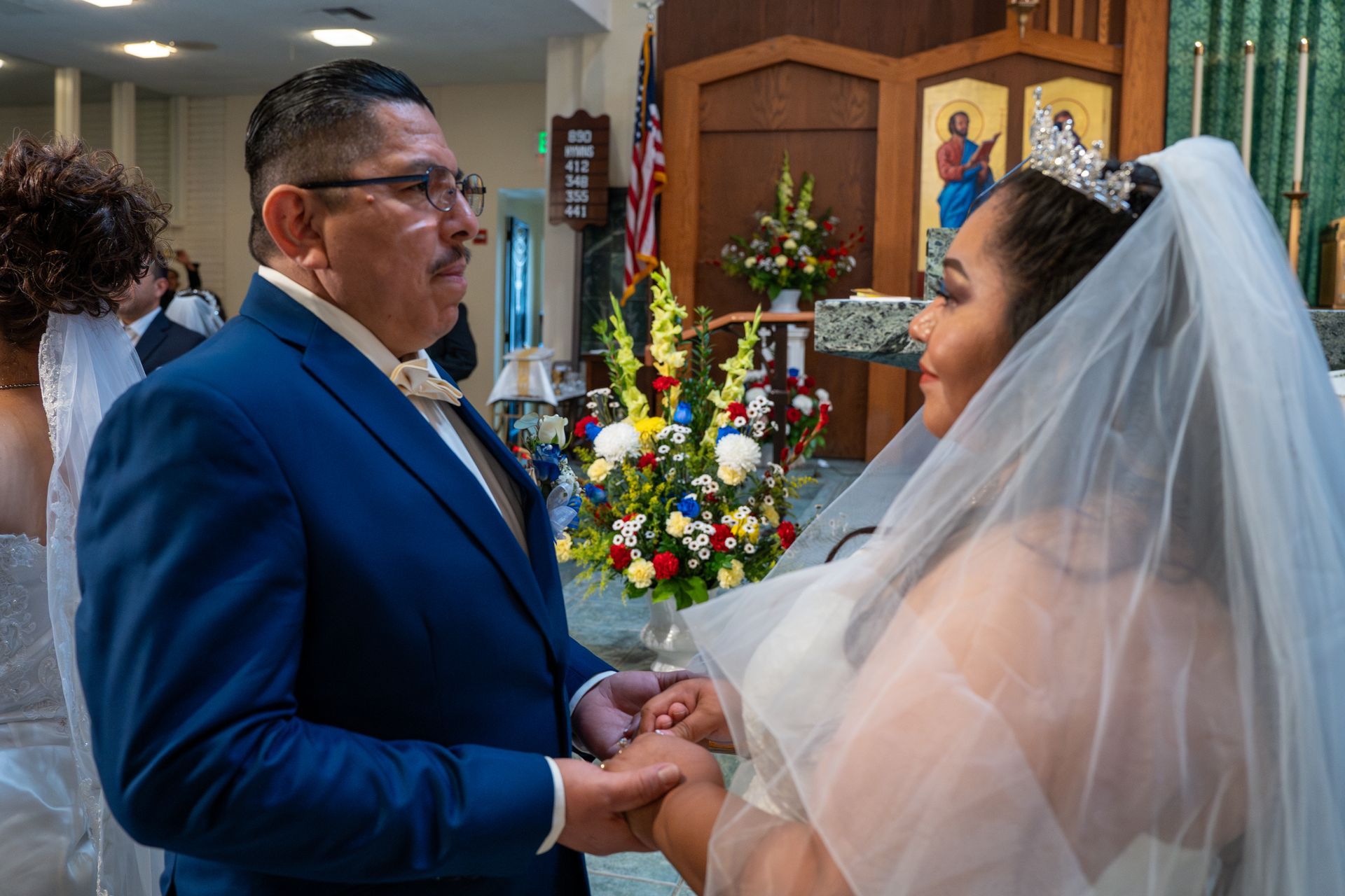 Bride and groom holding hands in a church during the wedding ceremony