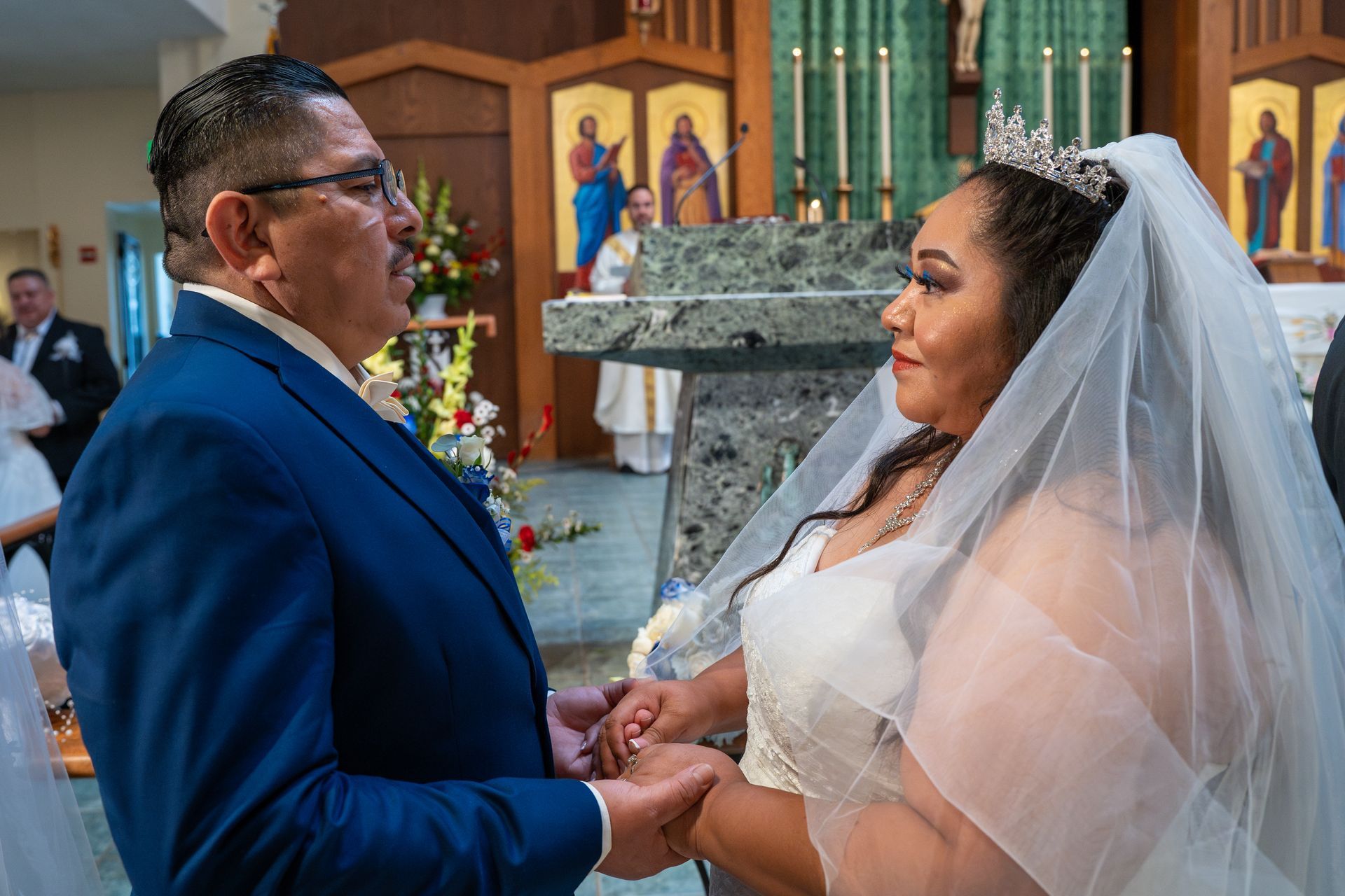 Bride and groom holding hands during a wedding ceremony inside a church