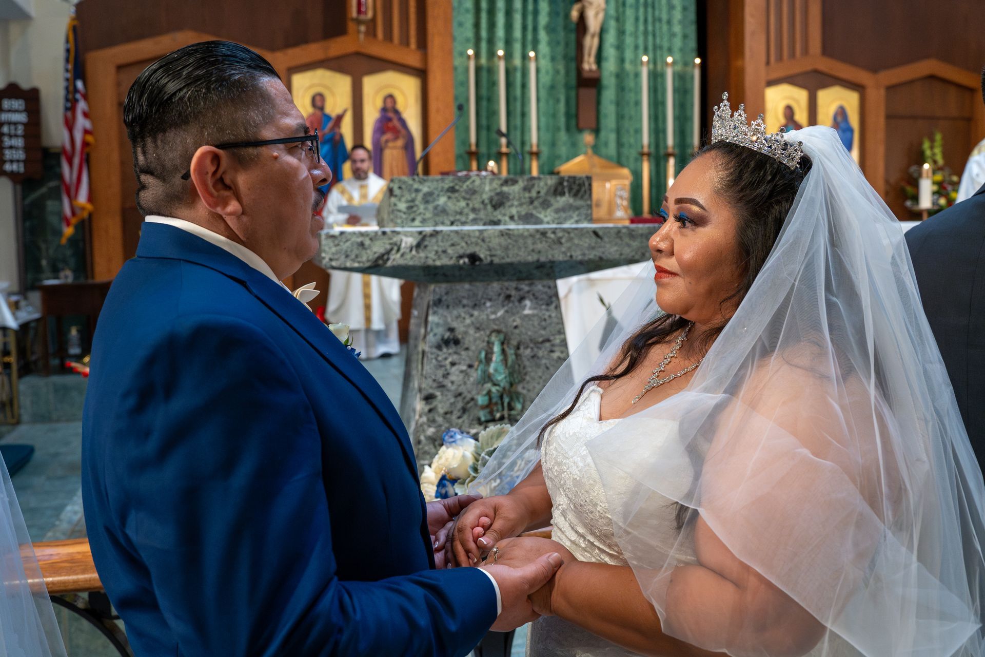 Bride and groom holding hands during a wedding ceremony inside a church