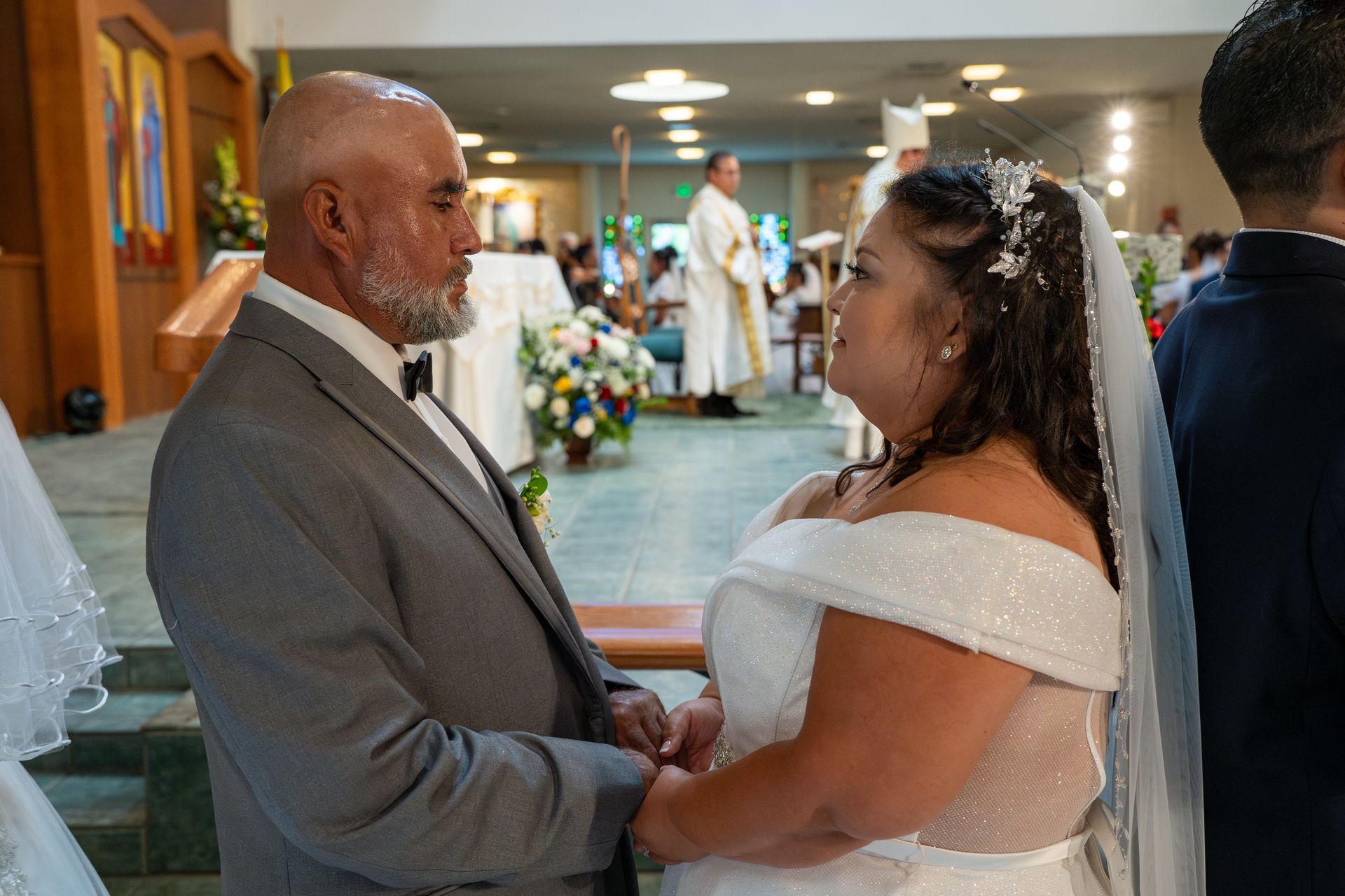 Bride and groom holding hands during a church wedding ceremony