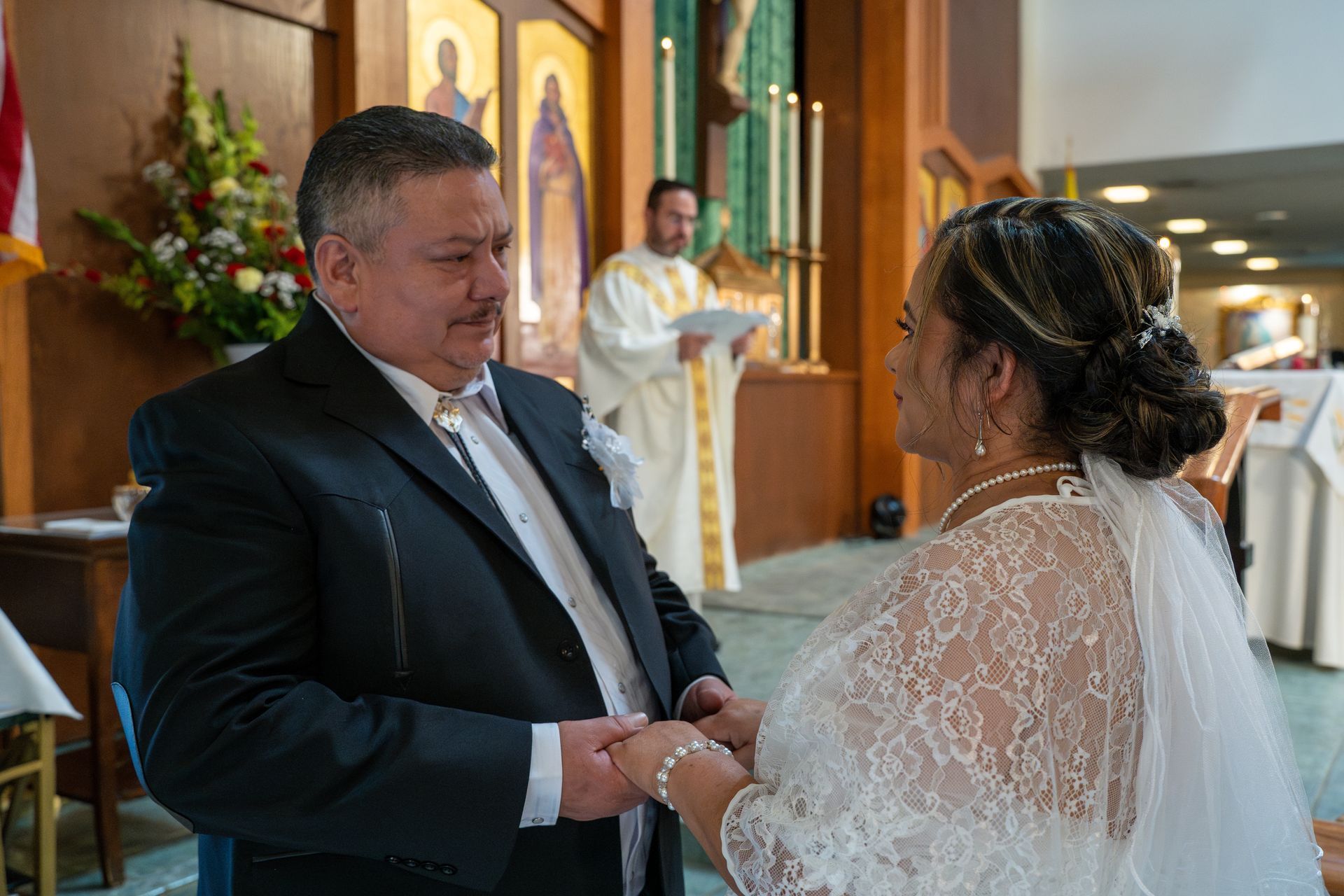 Couple exchanging rings during a wedding ceremony in a church.
