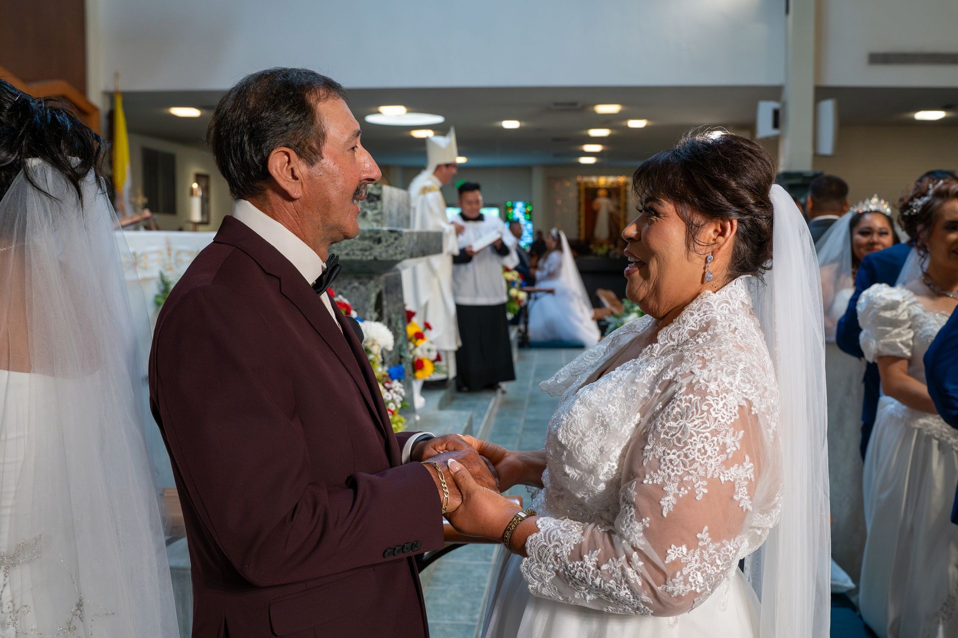 Bride and groom holding hands during a wedding ceremony indoors