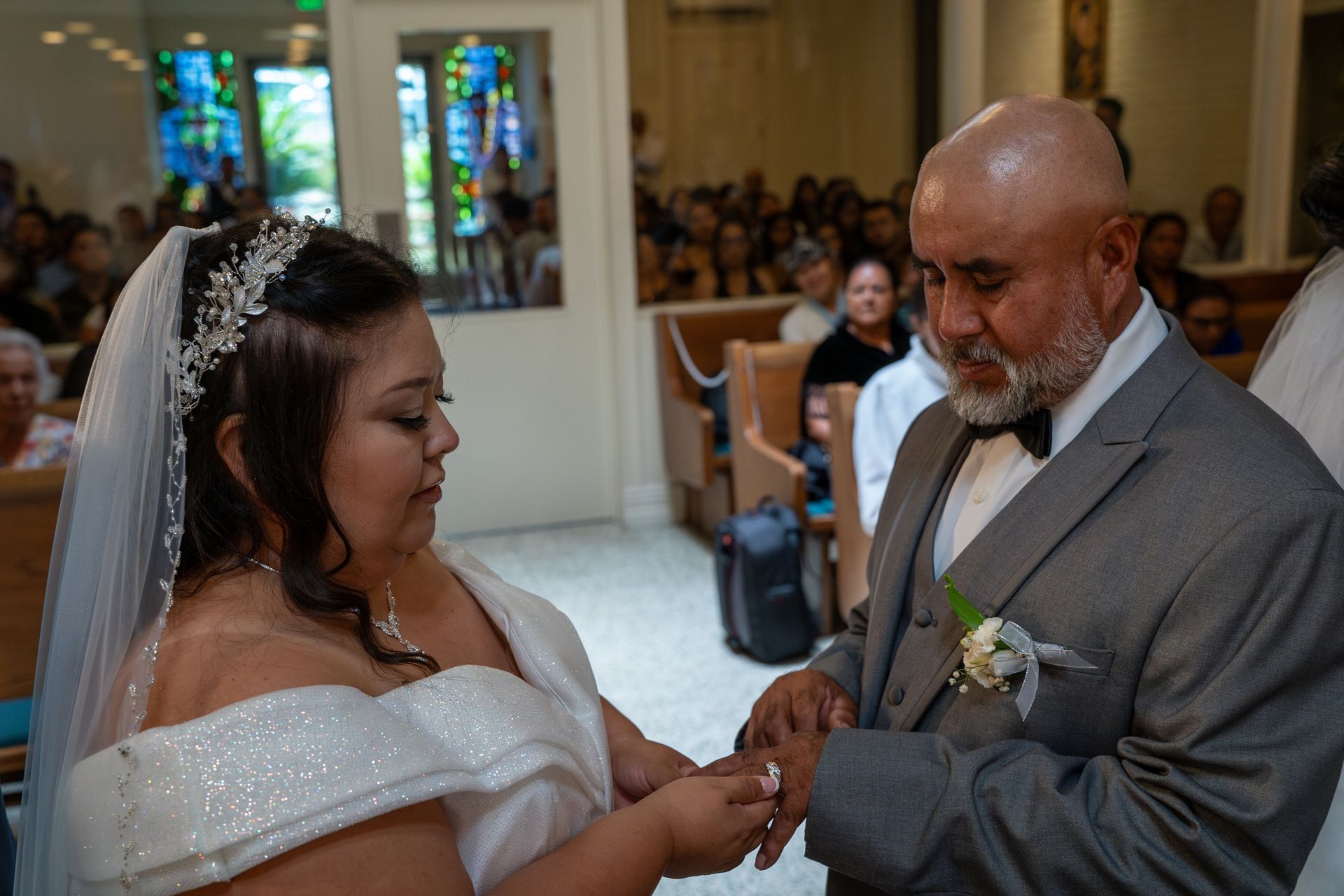 Bride and groom exchanging rings during a wedding ceremony in a church