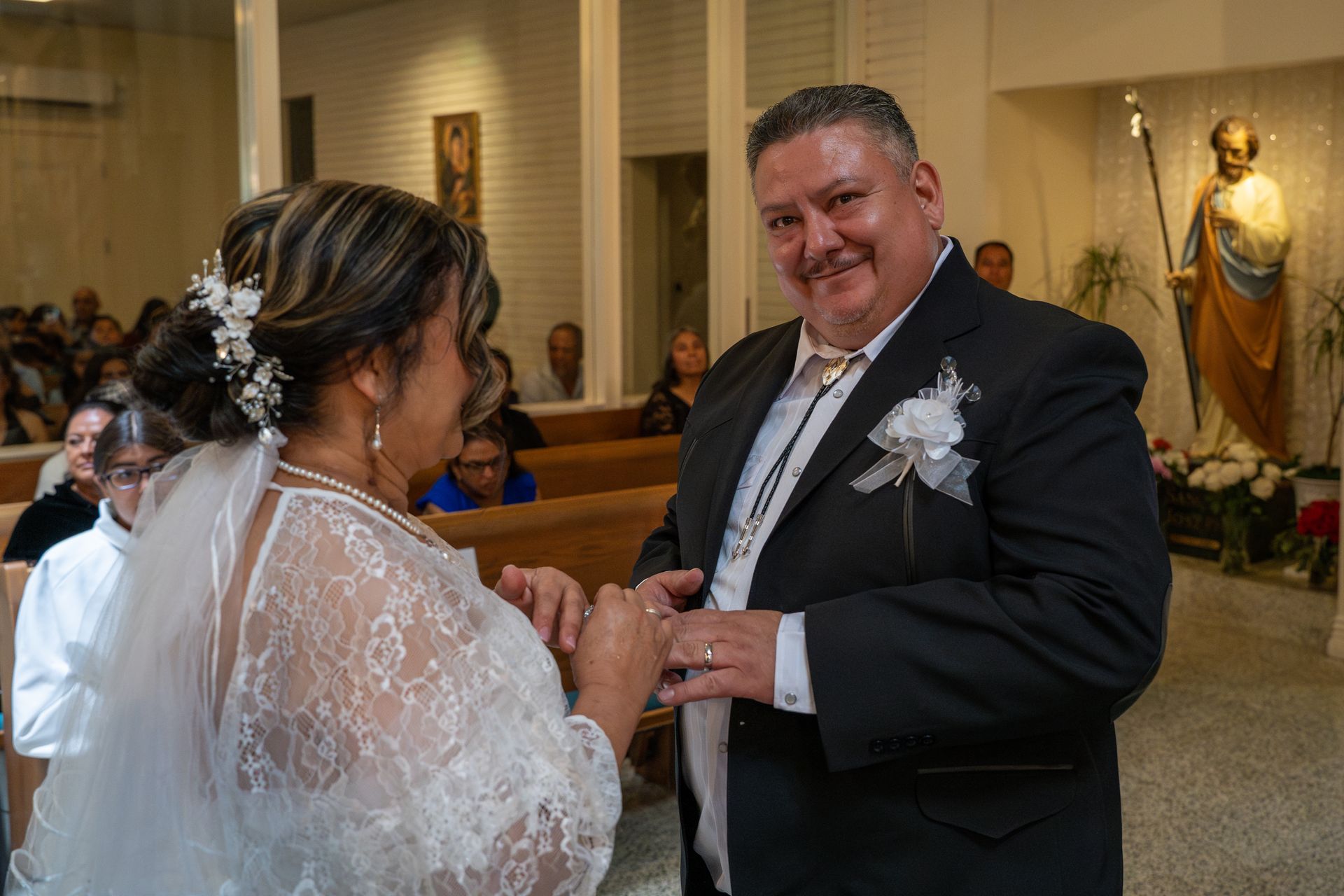 Bride and groom exchanging rings during a wedding ceremony in a church