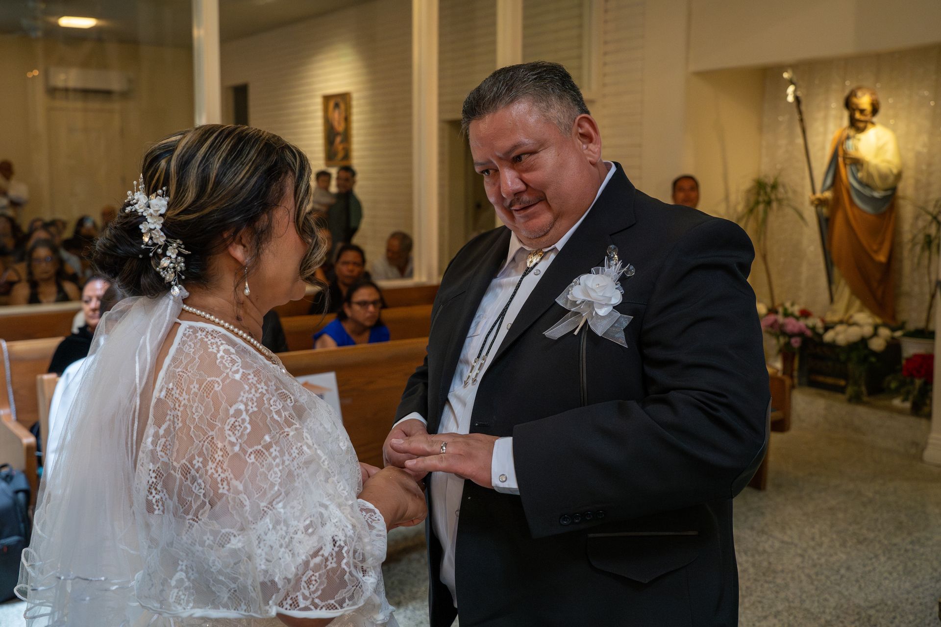 Bride and groom exchanging rings during a wedding ceremony in a church