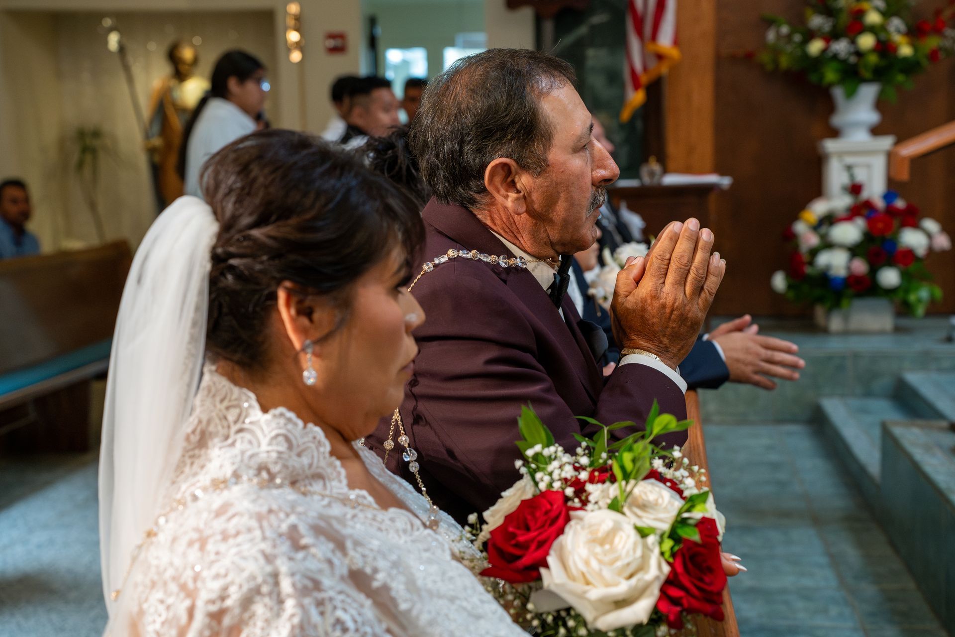 Bride and groom praying in a church during their wedding ceremony