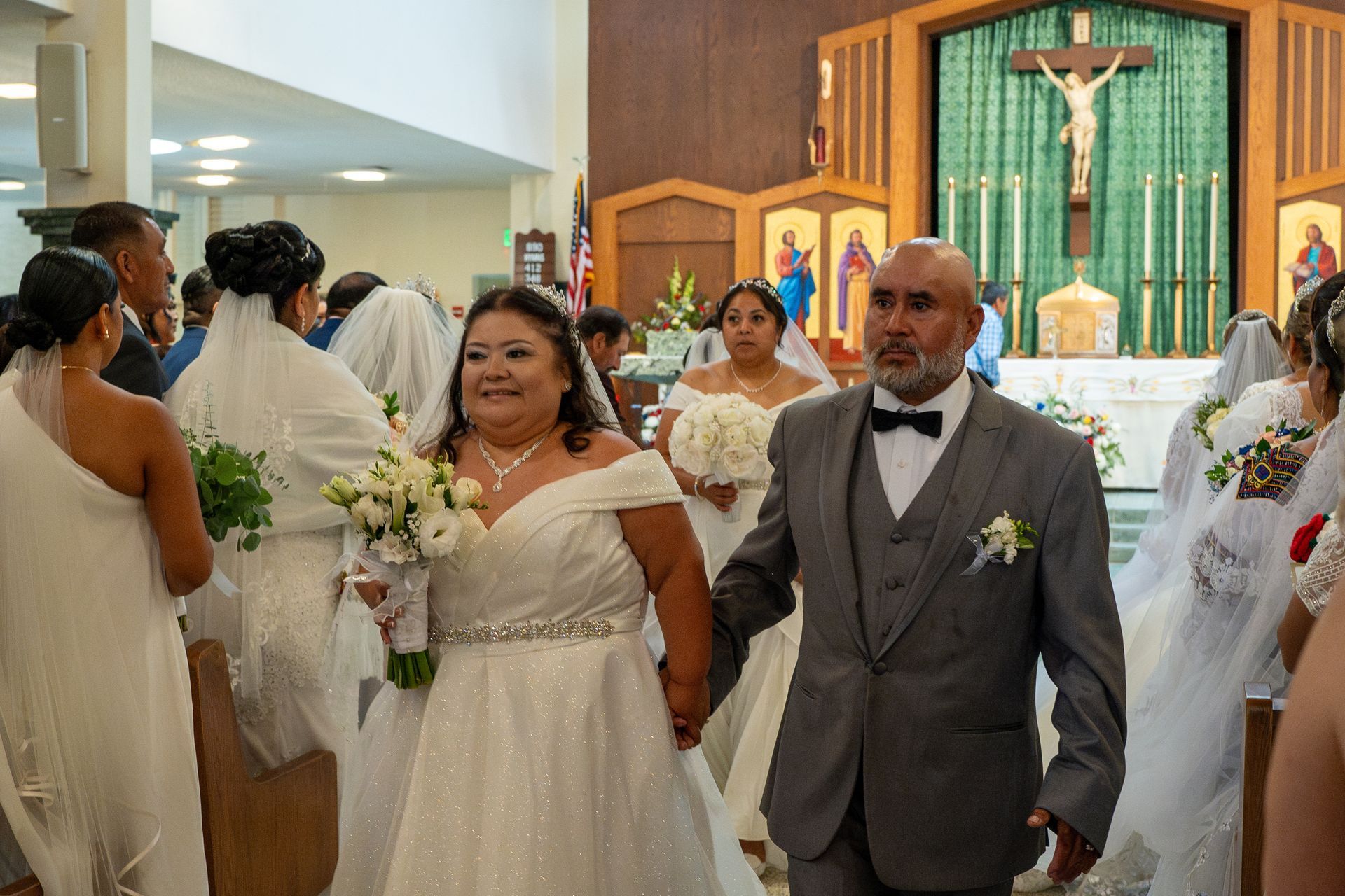 Bride and groom walk down the church aisle during a wedding ceremony.