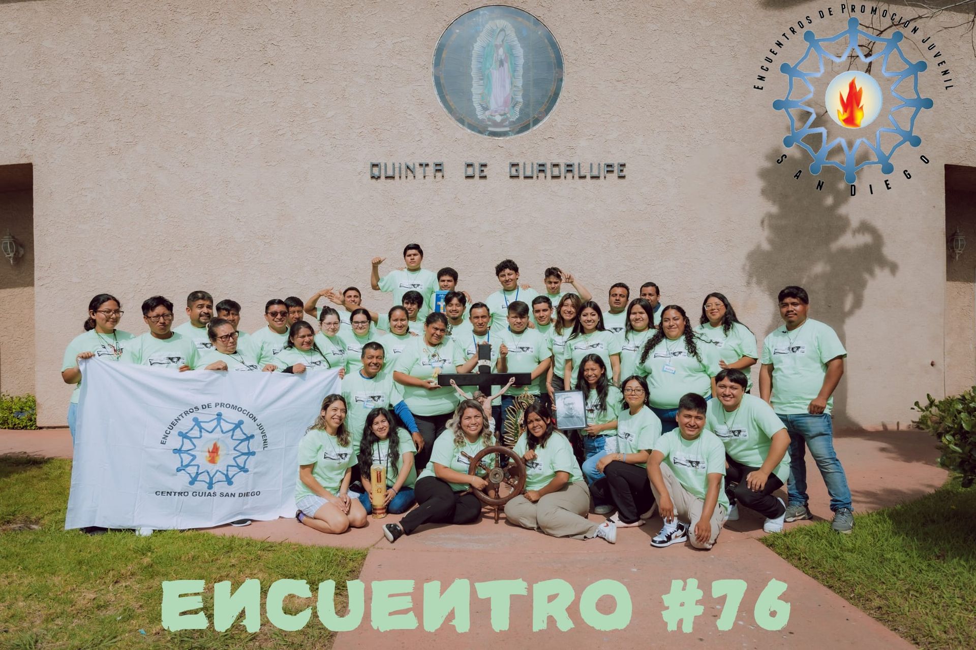 Group photo of people holding a banner in front of a building, with “Encuentro #76” text at the bottom.
