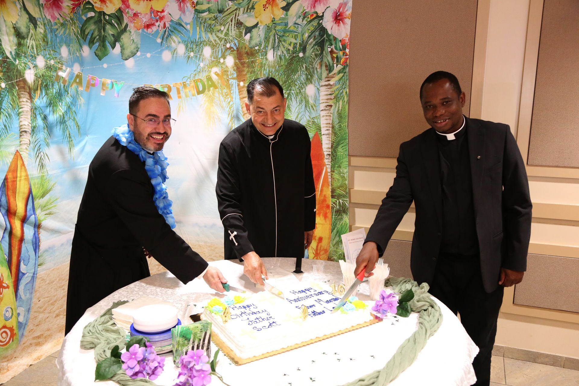 Three men cutting a decorated cake at a celebration table with flowers and a floral backdrop