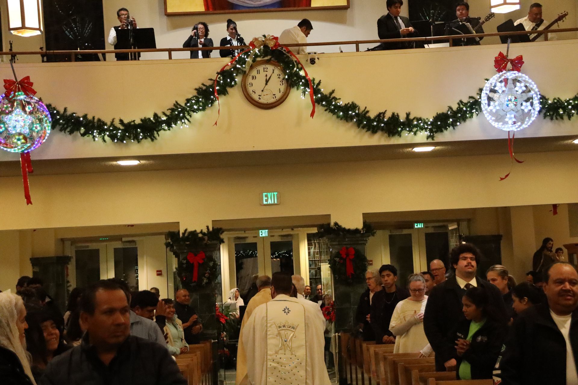 Christmas-decorated church interior with a congregation gathered during a service