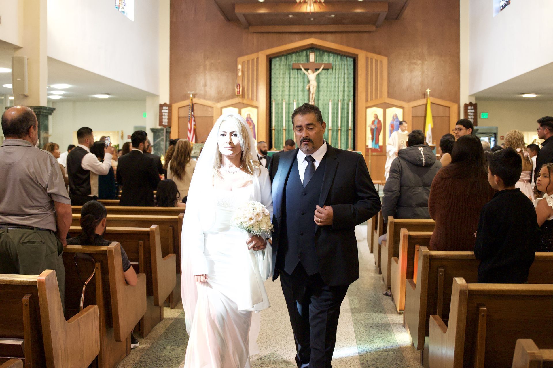 Bride and groom walking down the aisle in a church during a wedding ceremony
