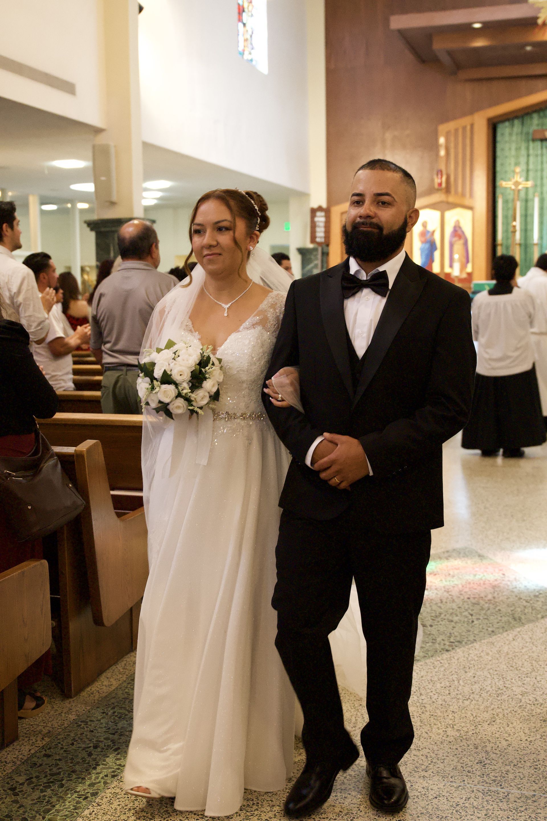Bride and groom walking down the church aisle during a wedding ceremony