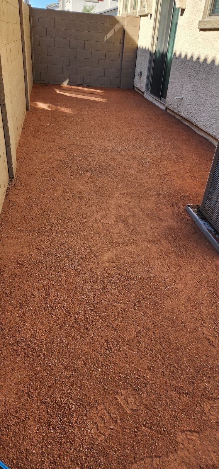 There is a lot of dirt on the ground in the backyard.