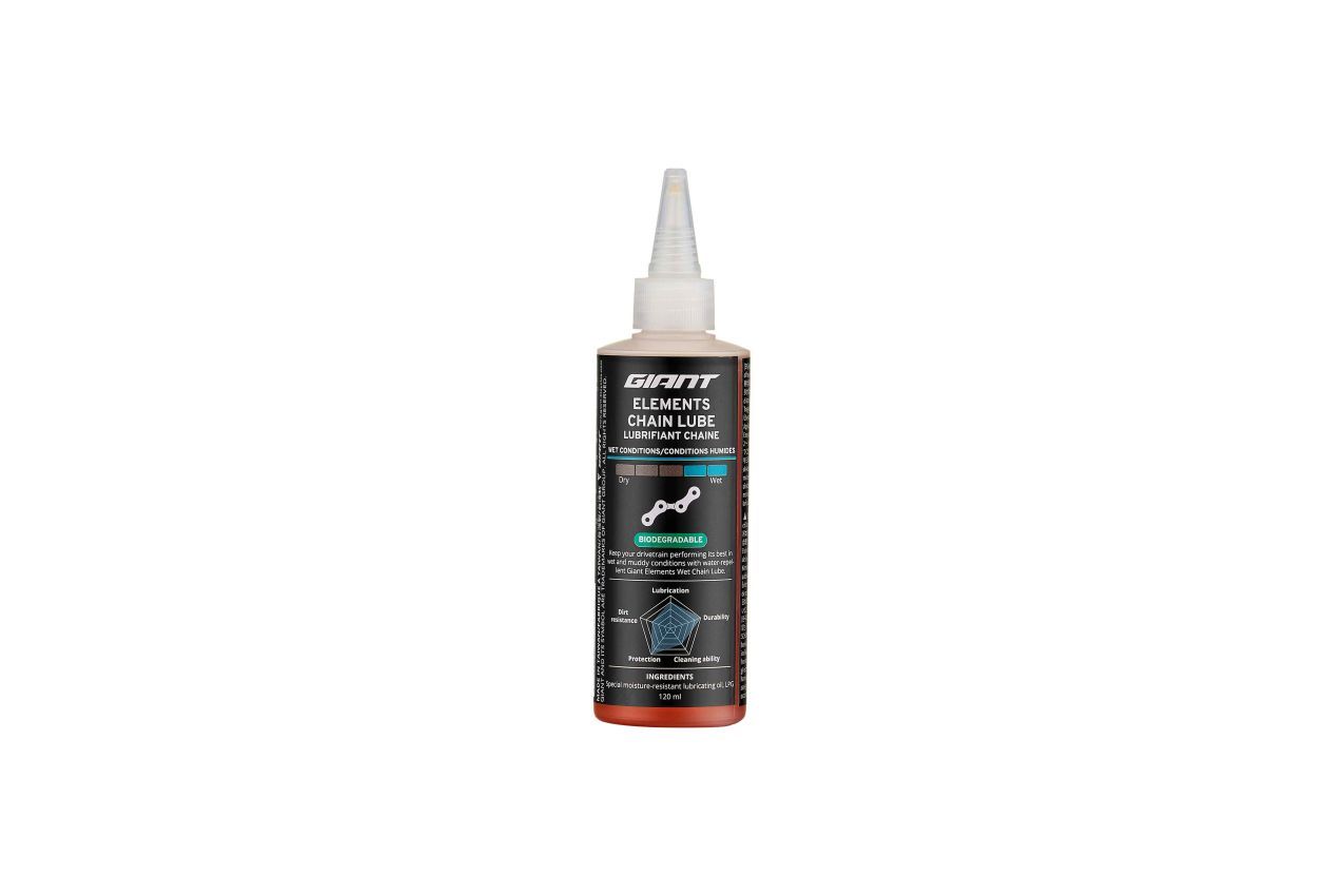 Bottle of orange liquid with a pointed nozzle, labeled with black and blue text.