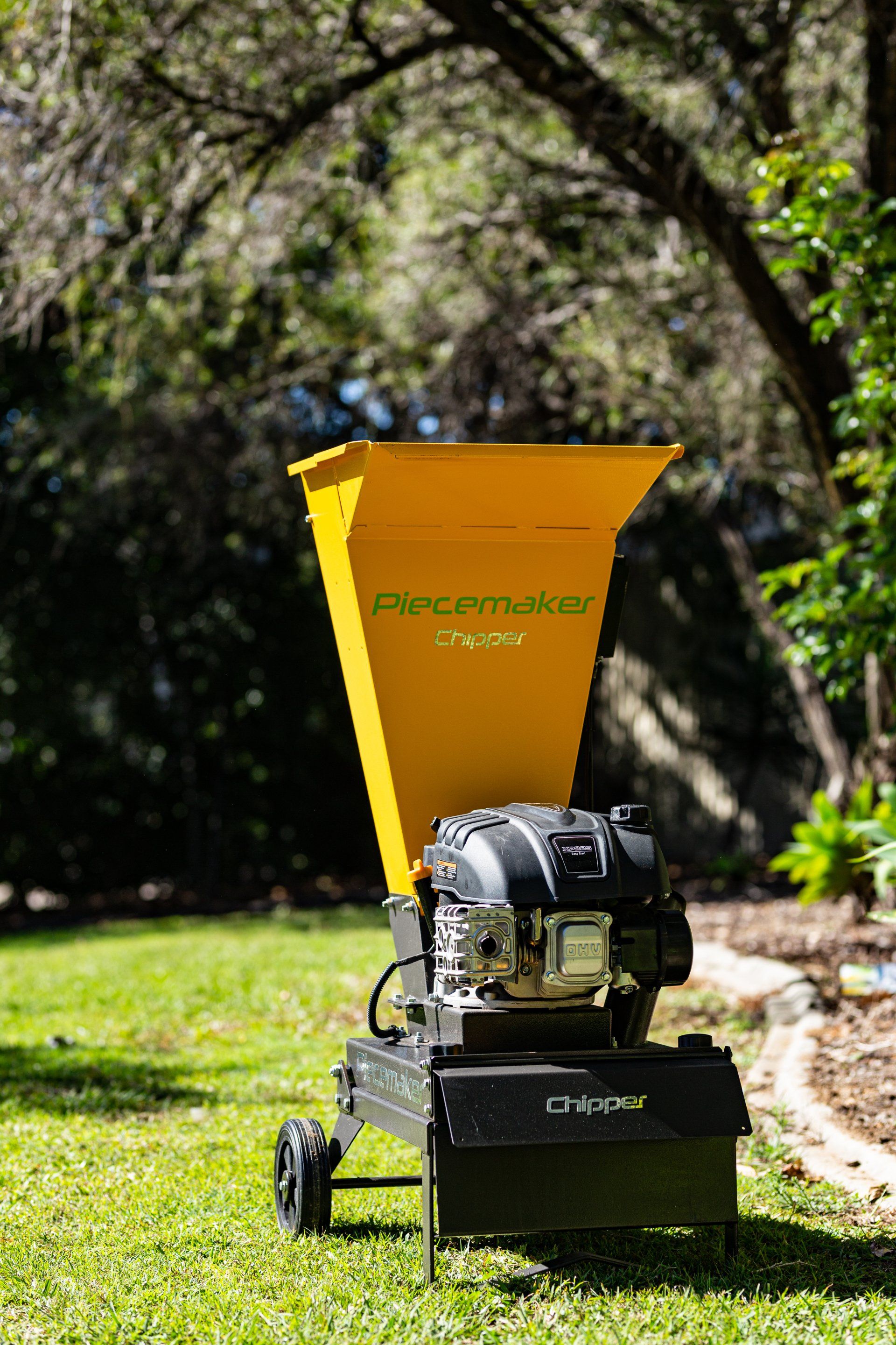 Electric Garden Shredder With Weathered Lawn And Pile Of Cut Tree Branches — The Saw Spot In Kyogle NSW