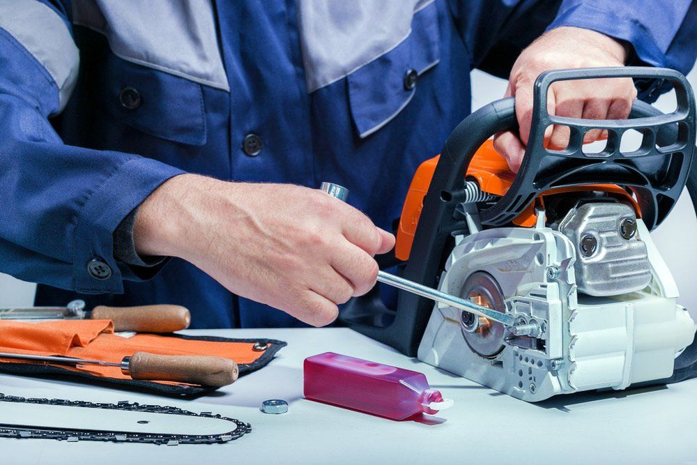 Professional Technician Repairing The Chainsaw Mower — The Saw Spot In Kyogle NSW
