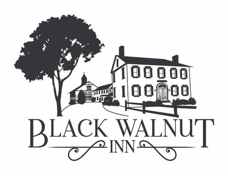A black and white logo for a hotel called black walnut inn