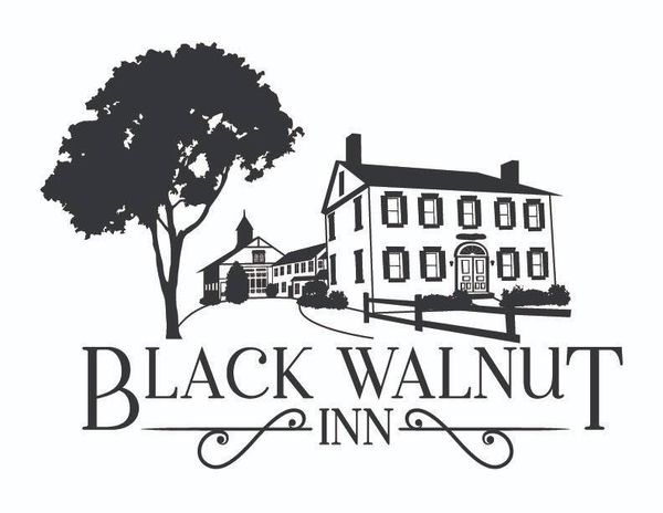 A black and white logo for a hotel called black walnut inn