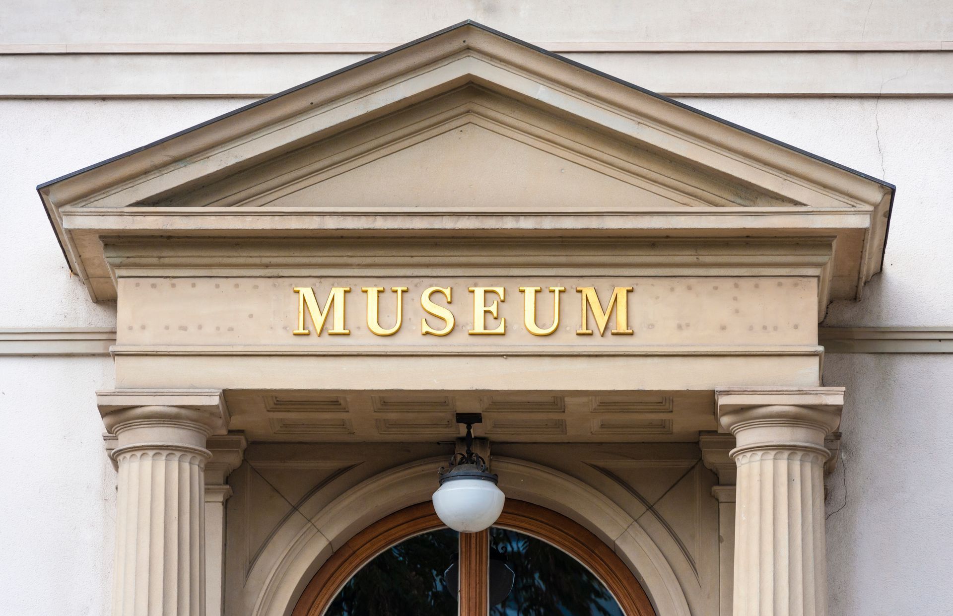 Museum entrance with gold lettering and classical columns.