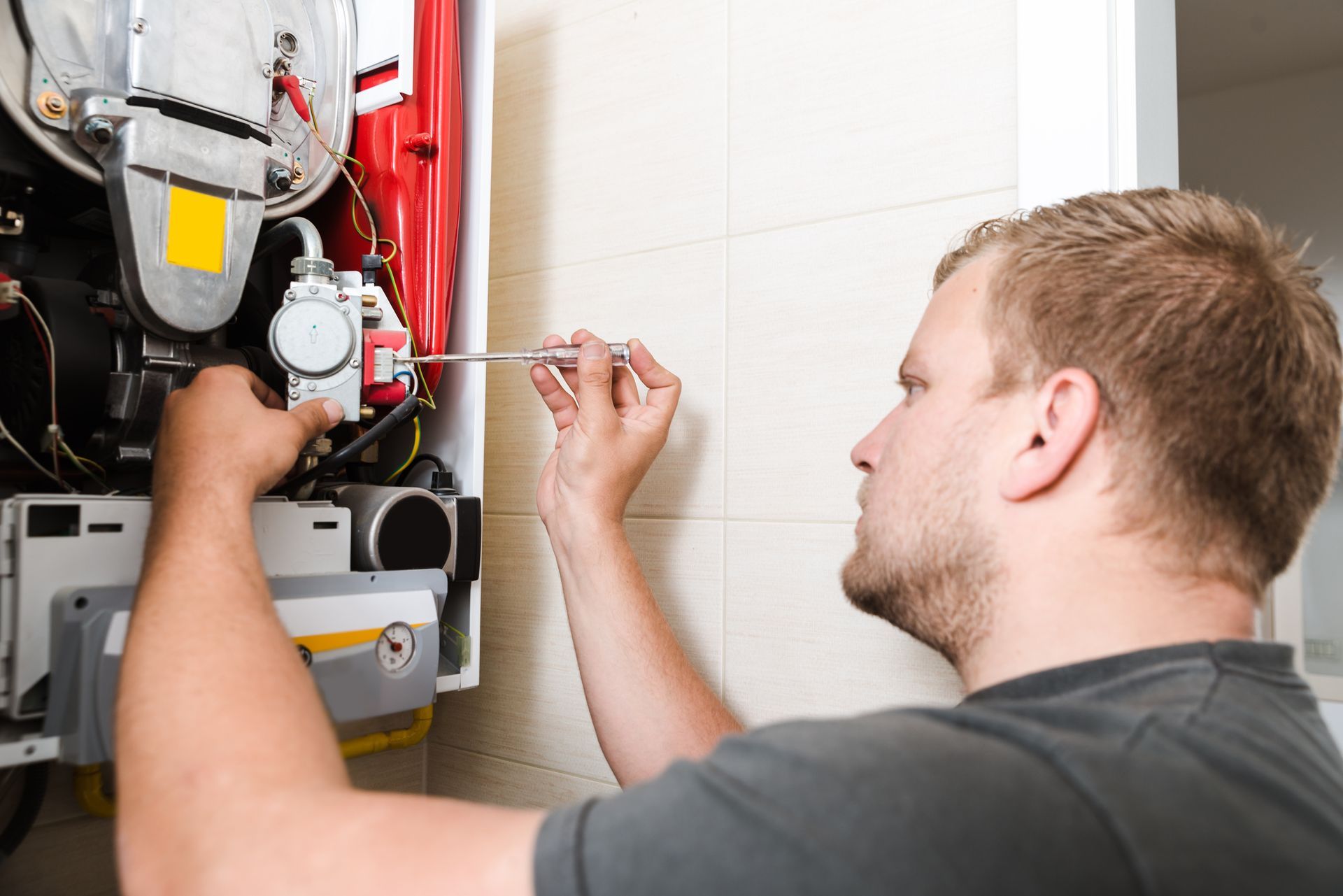 Furnace Repair: Skilled Technician Fixing a Gas Furnace.