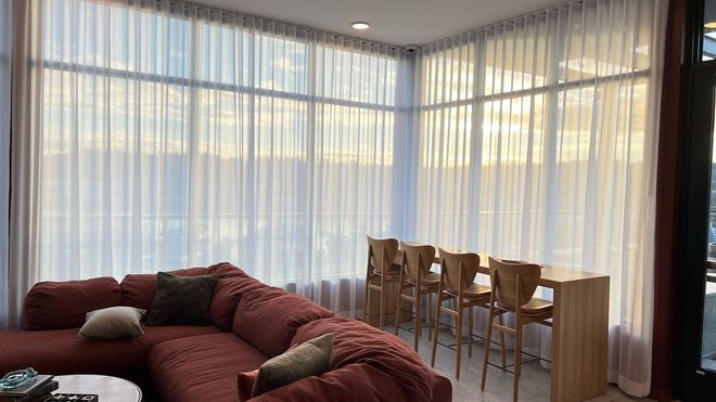 Floor-to-ceiling sheer drapery for large living room windows