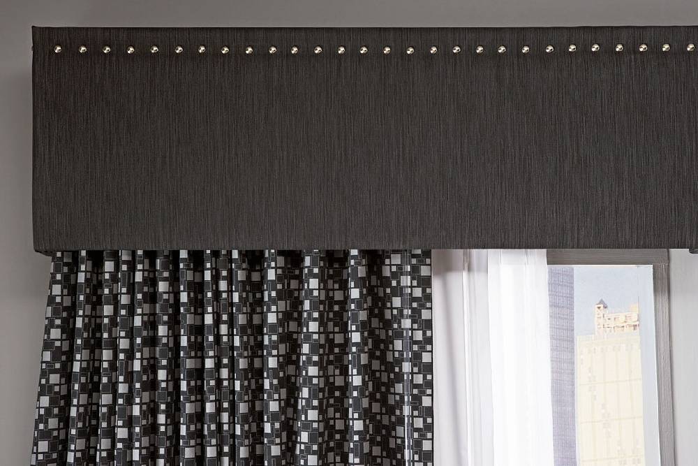 Contemporary cornice board idea featuring sleek black finish paired with geometric drapes.