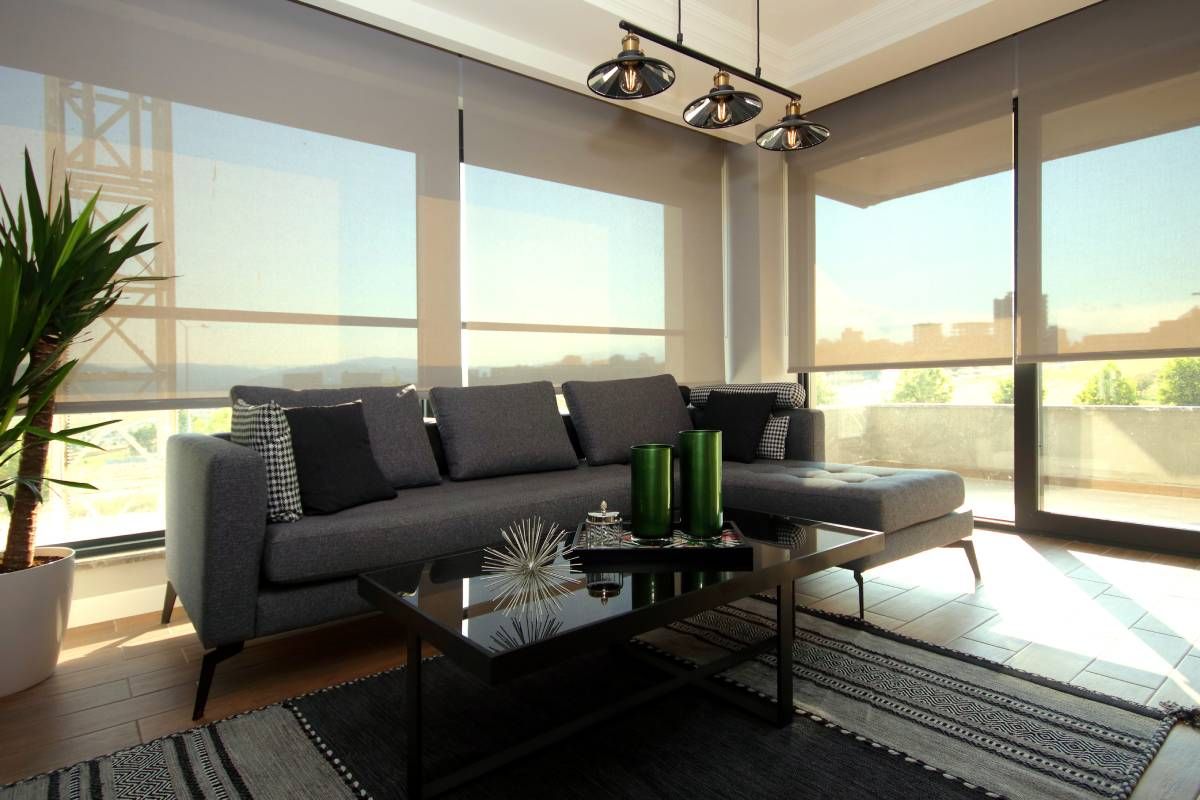 Modern living room with floor-to-ceiling windows featuring the best motorized shades for light control.