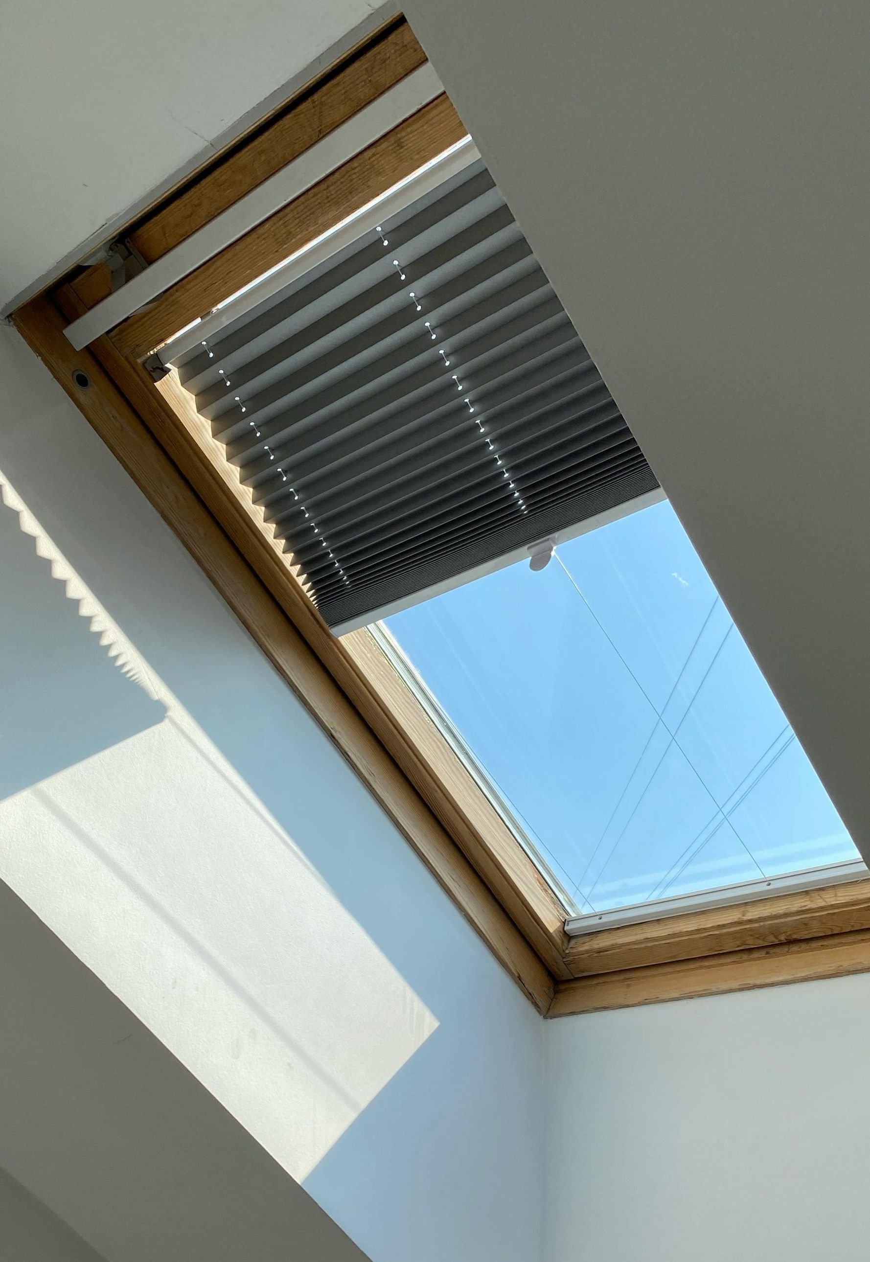 Modern motorized skylight shades offering light control and energy efficiency for homes.