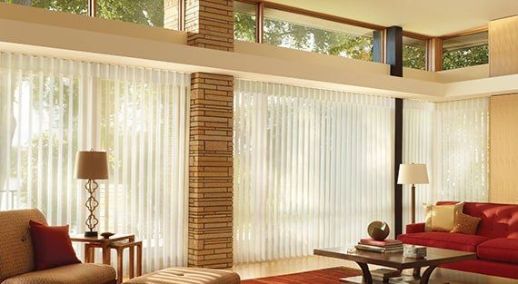 Bright living room with custom sheer window treatments for spring lighting