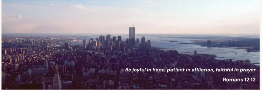 an aerial view of a city with a quote from romans 12:10
