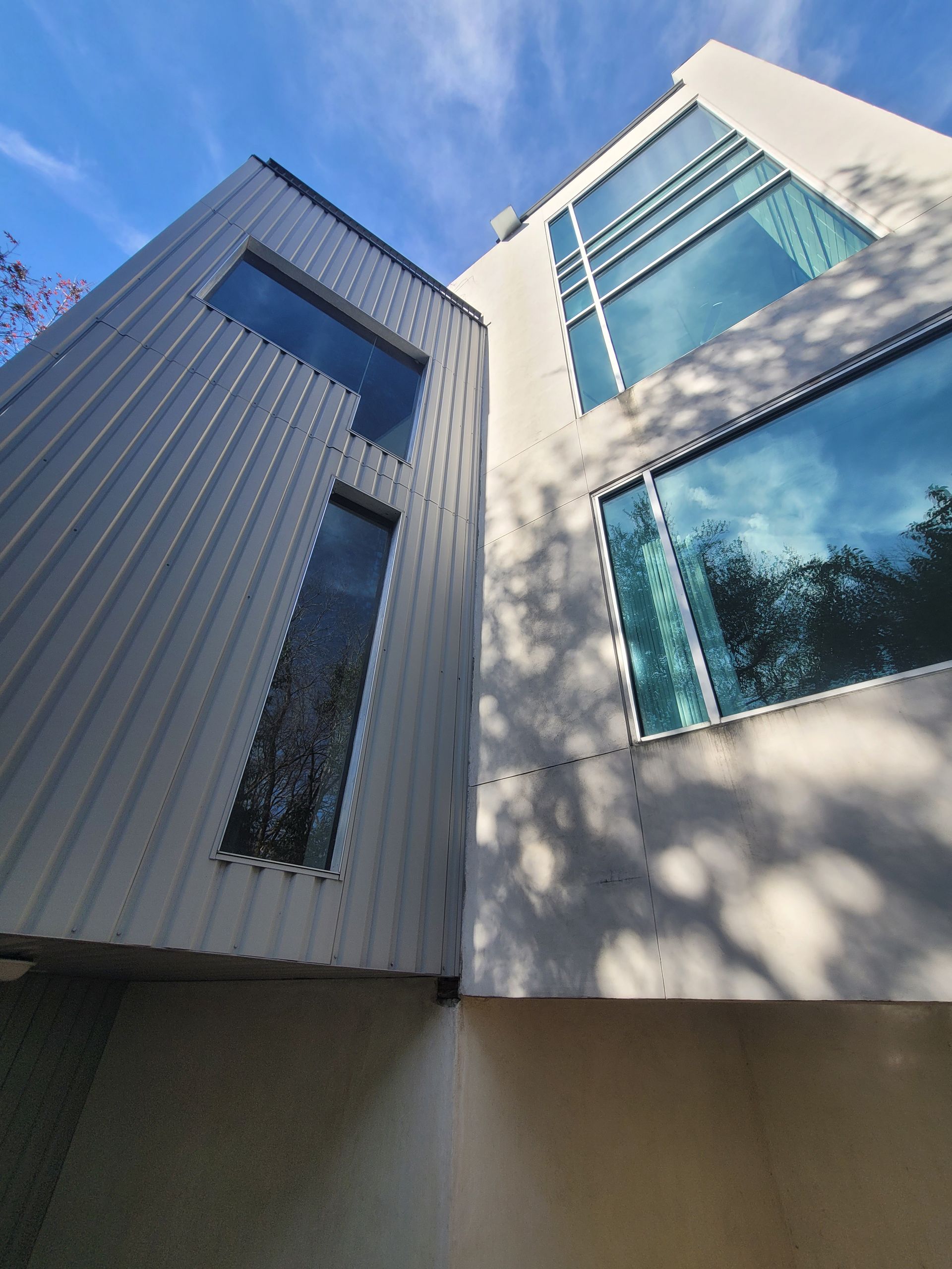 Close view of clean exterior wall meeting clean windows on an Austin home