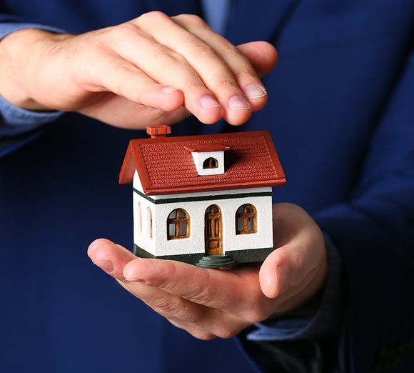 Person holding house model Person holding house model