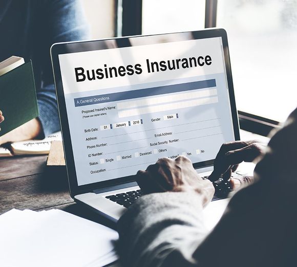 Person filling out business insurance form Person filling out business insurance form