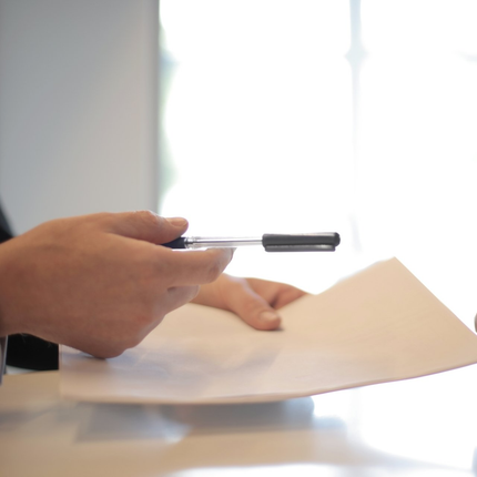 Person filling out business insurance form Person filling out business insurance form