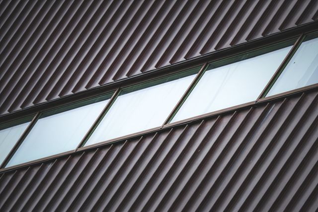 Angled glass skylight set into a dark corrugated metal roof