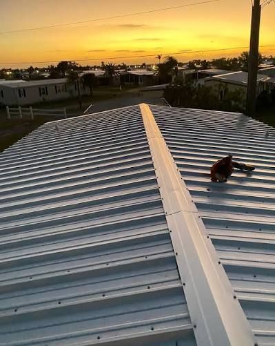 Close-up of gray corrugated metal roofing with diagonal ridges and shadows