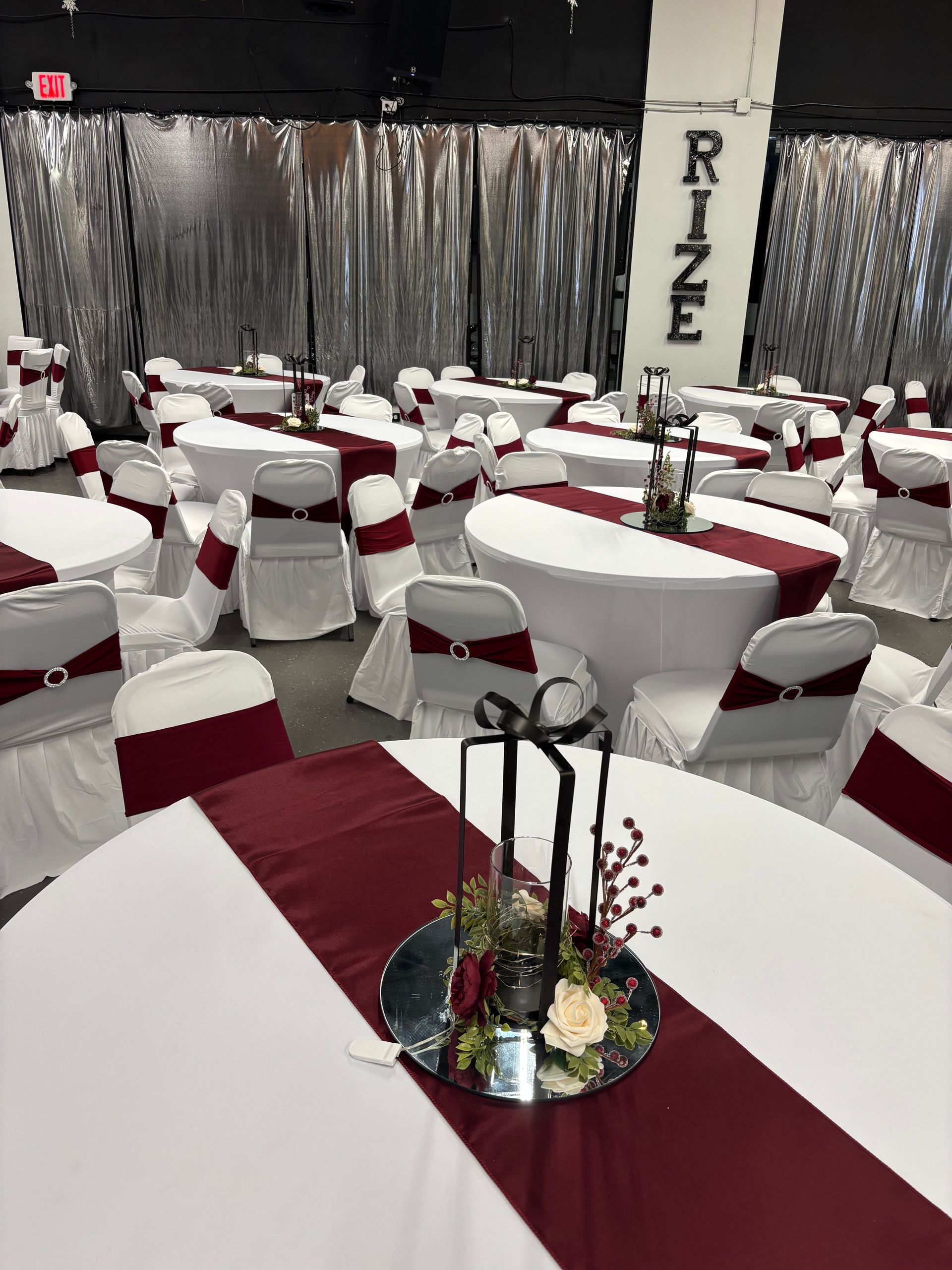A large room with tables and chairs set up for a party.