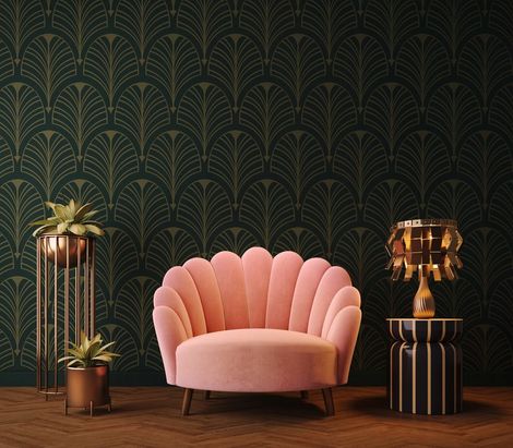 Poltrona rosa con schienale a conchiglia al centro di una stanza in stile art déco dai toni scuri, con carta da parati verde a motivi geometrici e dettagli dorati.