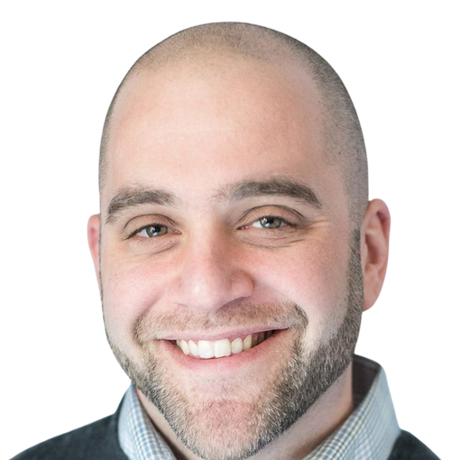 Smiling bald man with a short beard and light blue shirt against a white background