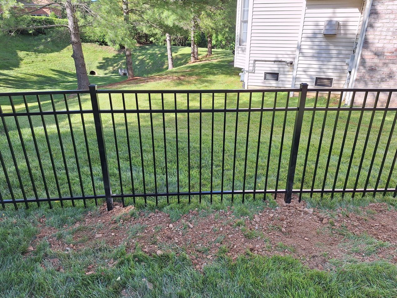 Black aluminum fence in yard.