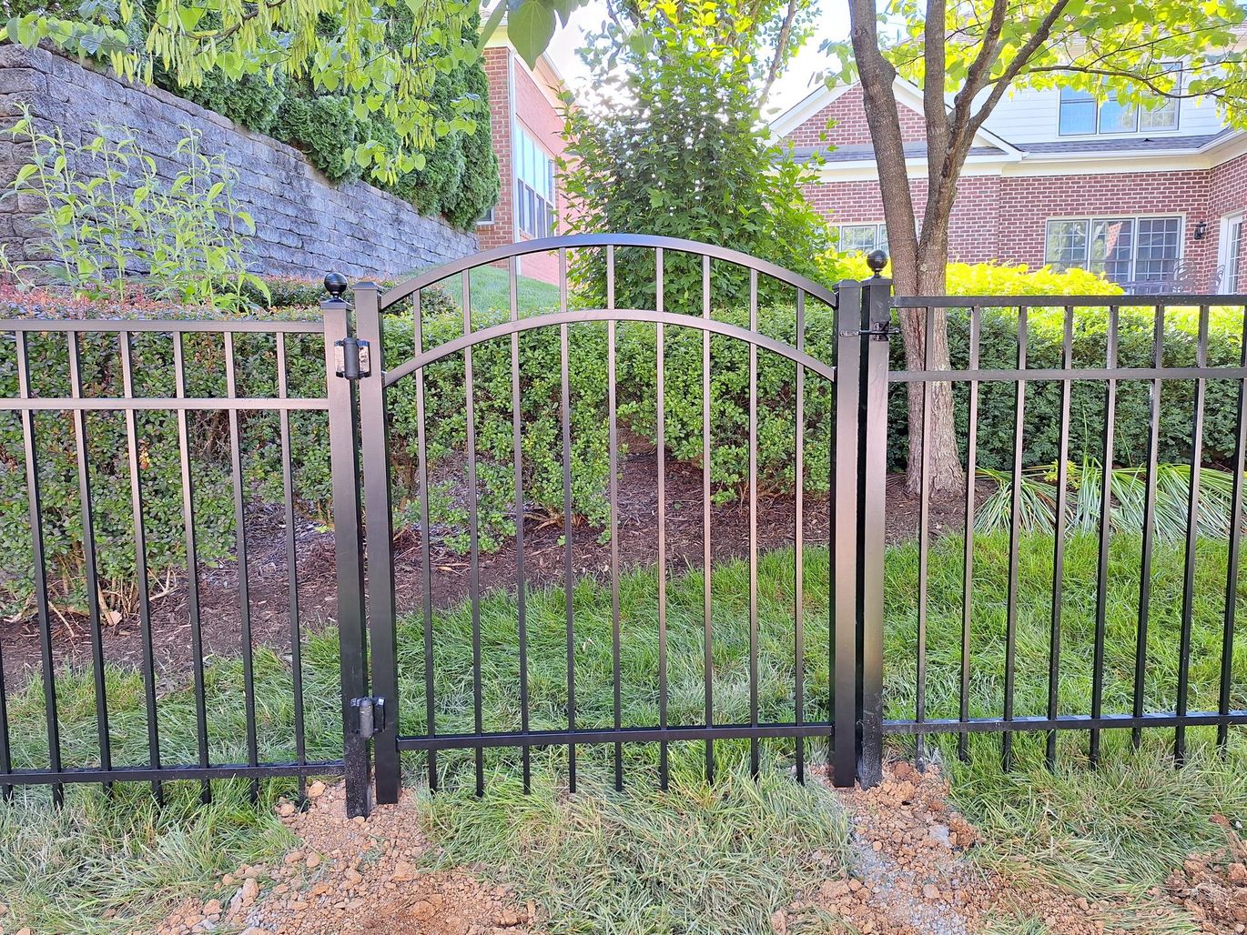 Black metal fence on grass.