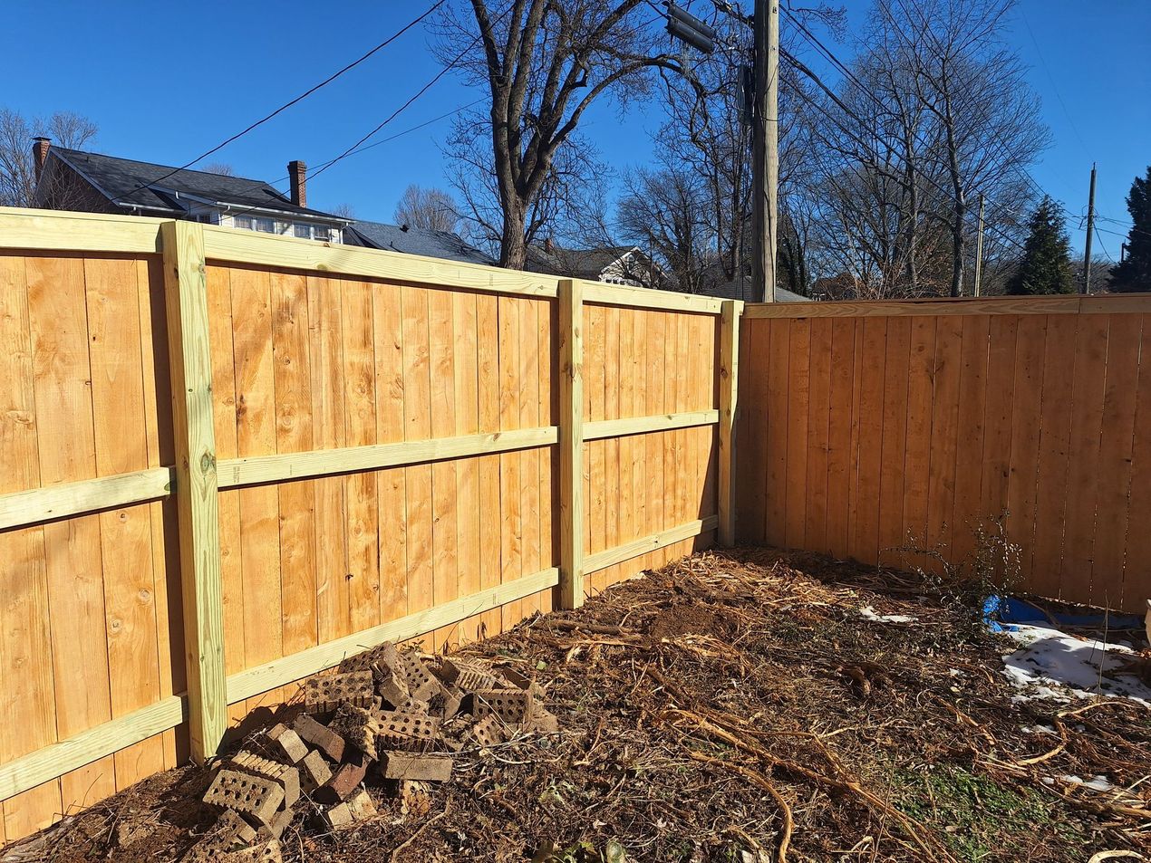 A Wooden Fence Is Sitting in The Middle of A Yard.